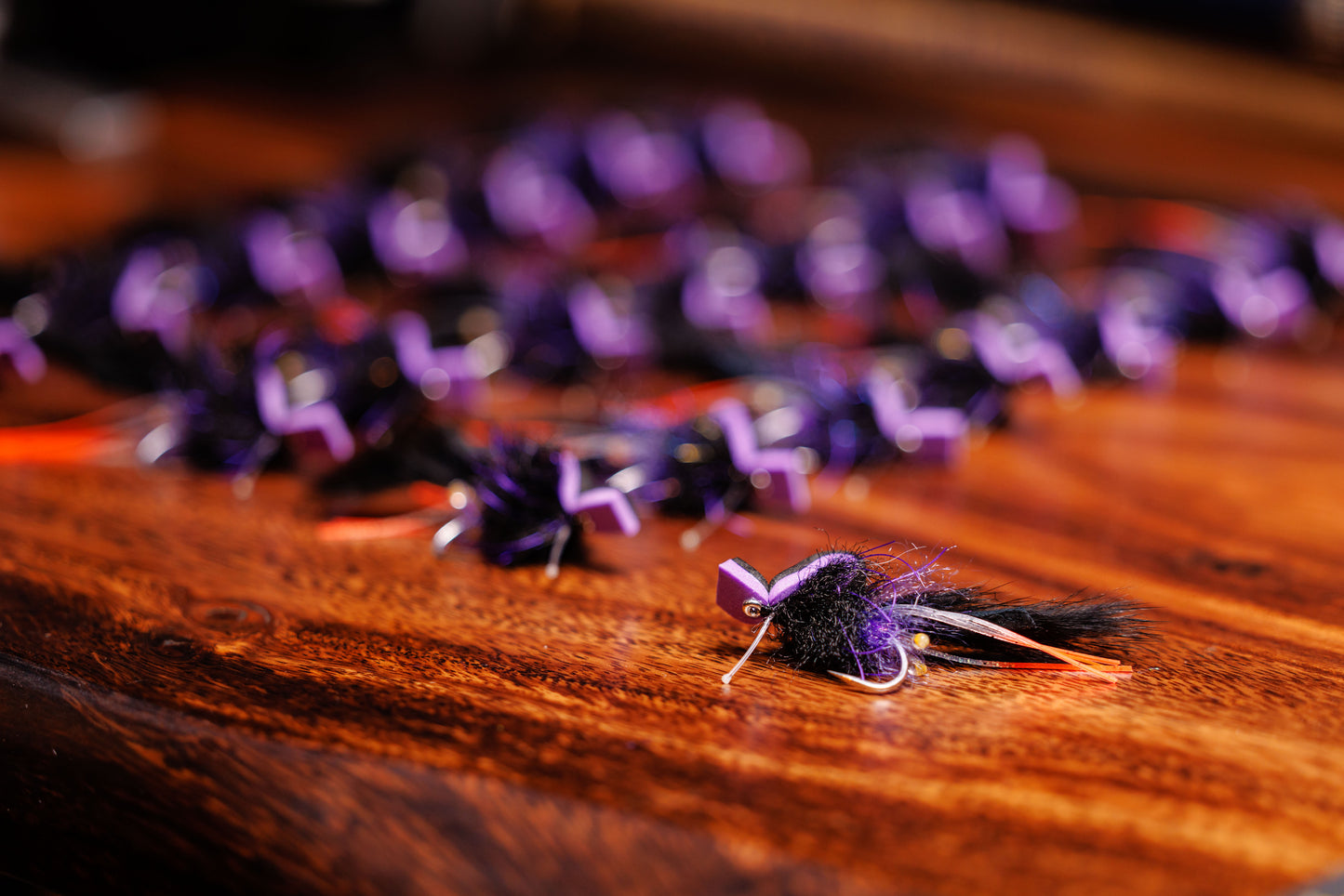 Close-up of purple fishing lures on a wooden surface