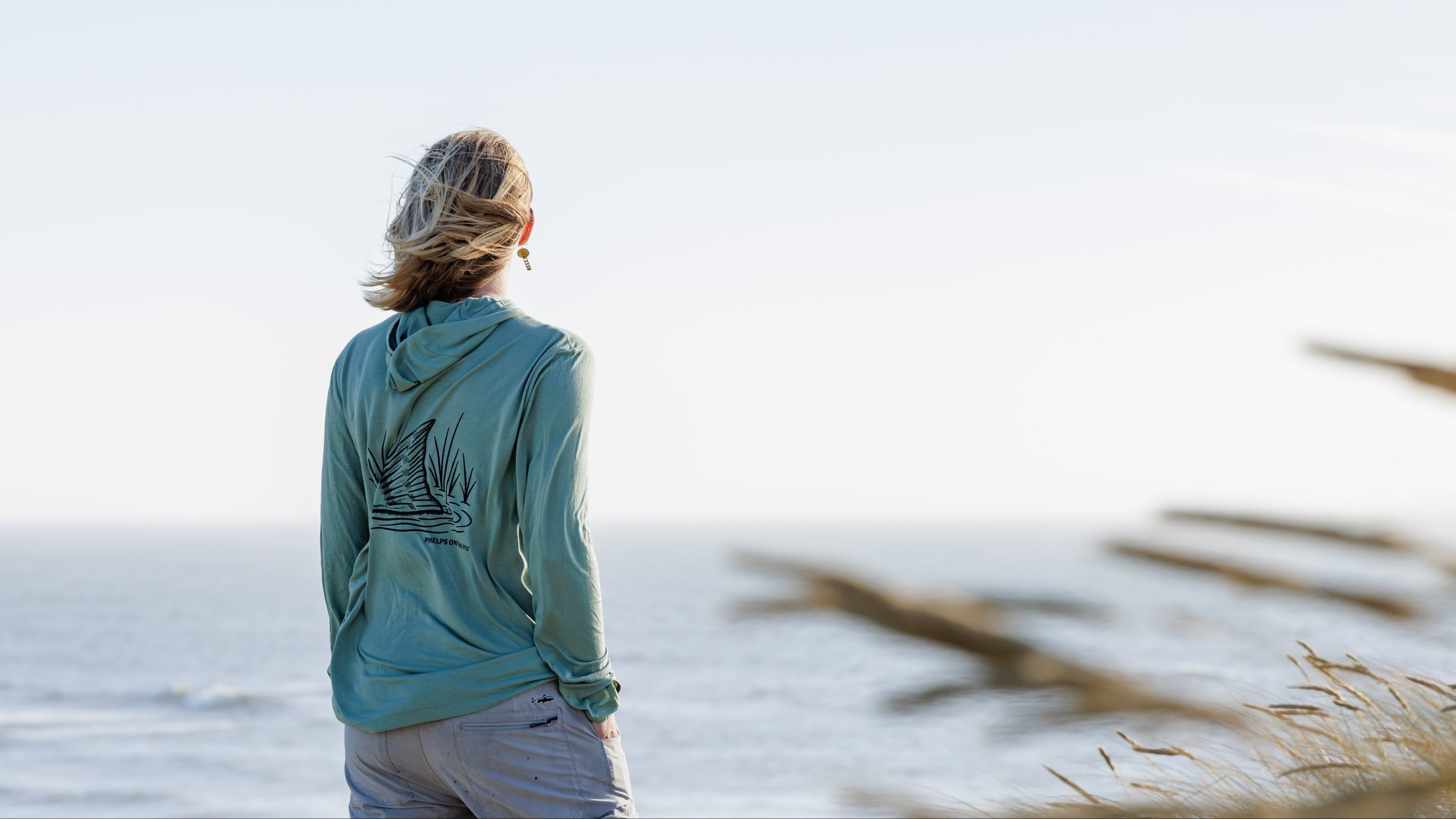 Person walking on a beach with a blurred background